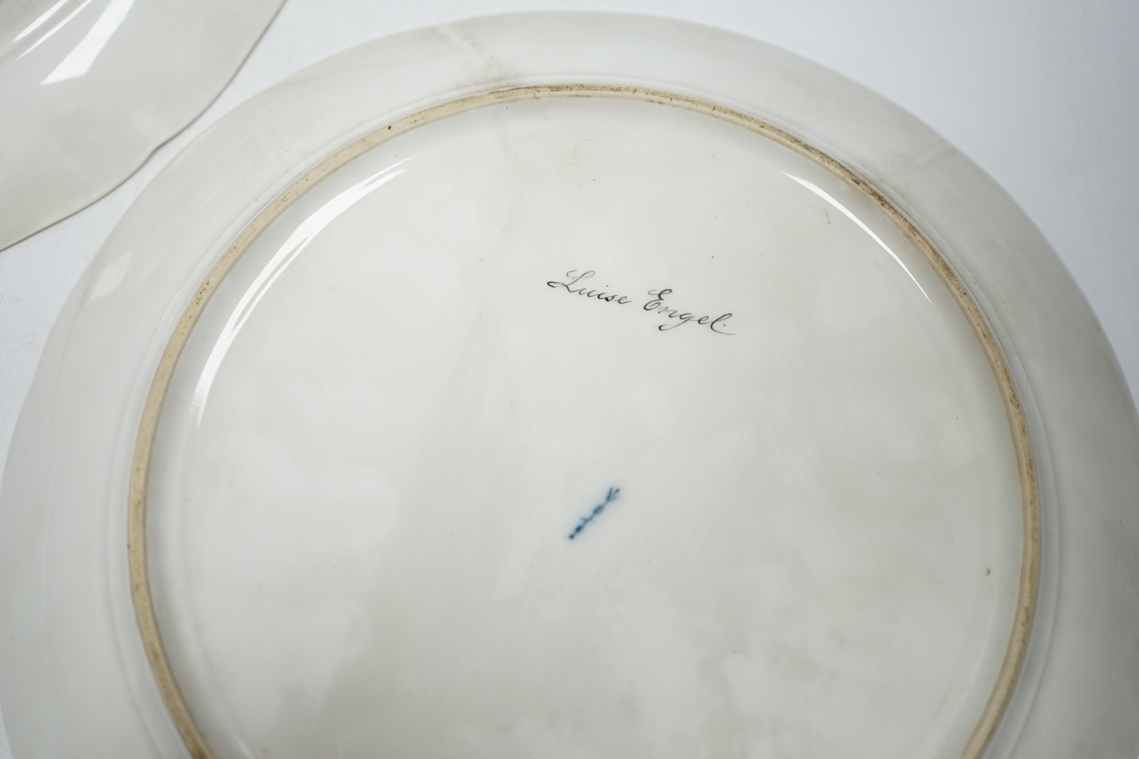 A pair of late 19th century Berlin plates, hand painted with females, 21.5cm